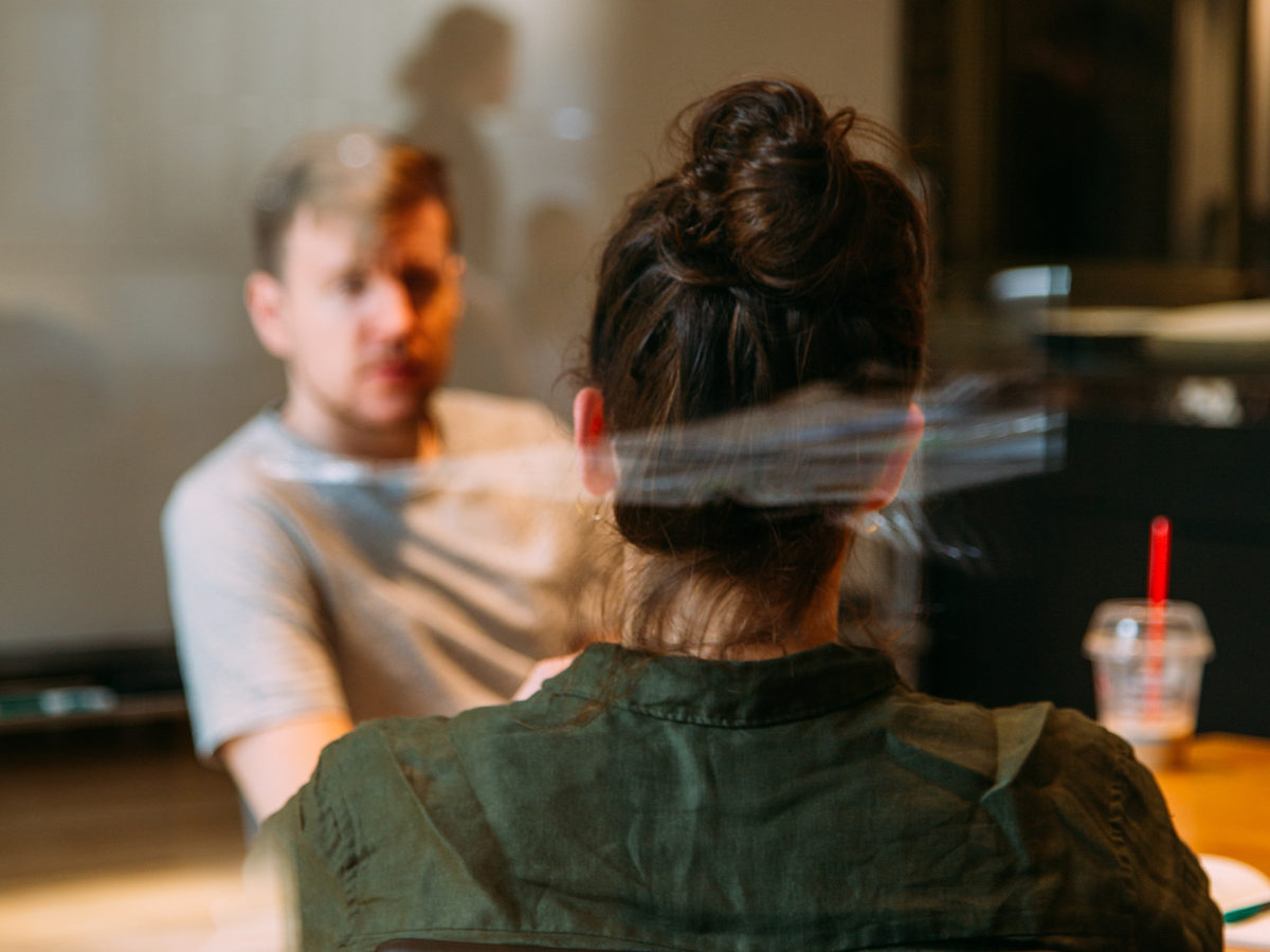 Two people talking across a table.